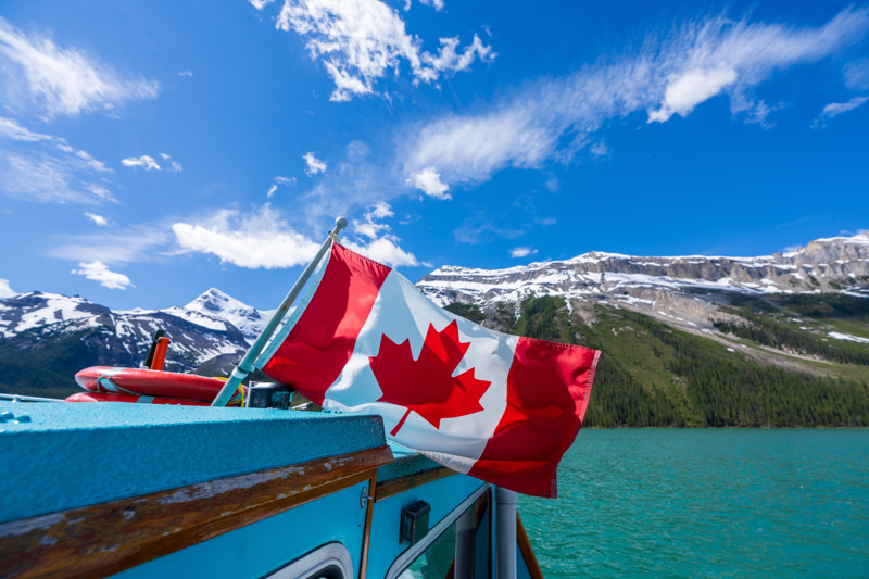 Canadian flag with Maligne Lake in the background